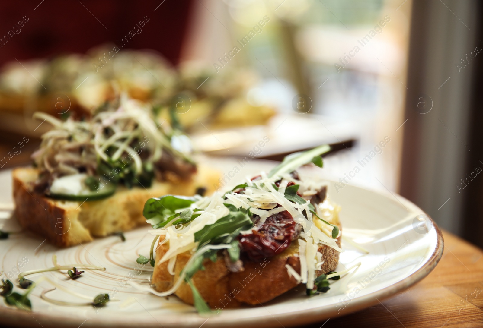 Photo of Delicious bruschettas with fish on table, closeup