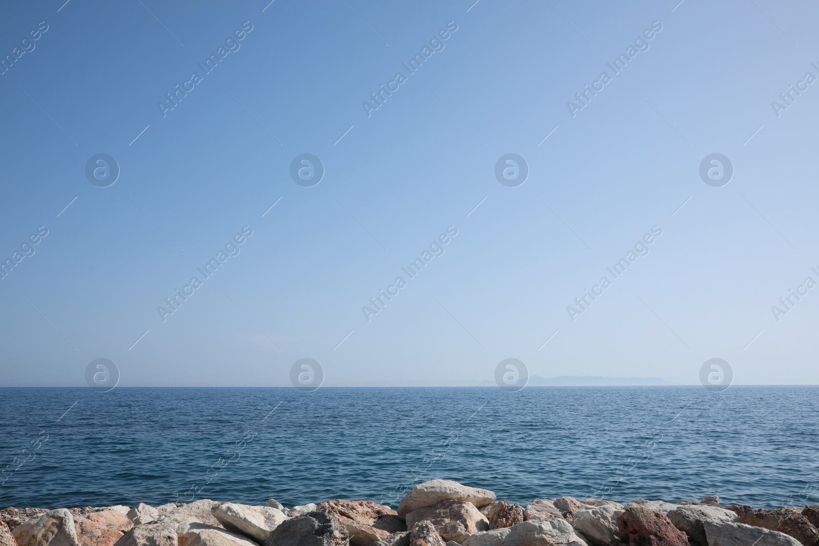 Photo of Beautiful view of rocky beach and calm sea on sunny day