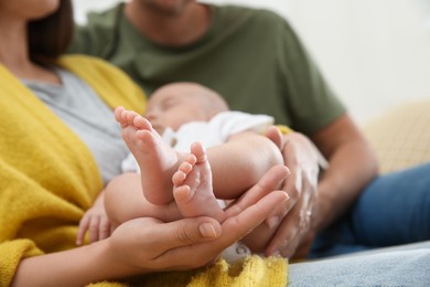 Photo of Lovely couple holding their sleeping baby, closeup