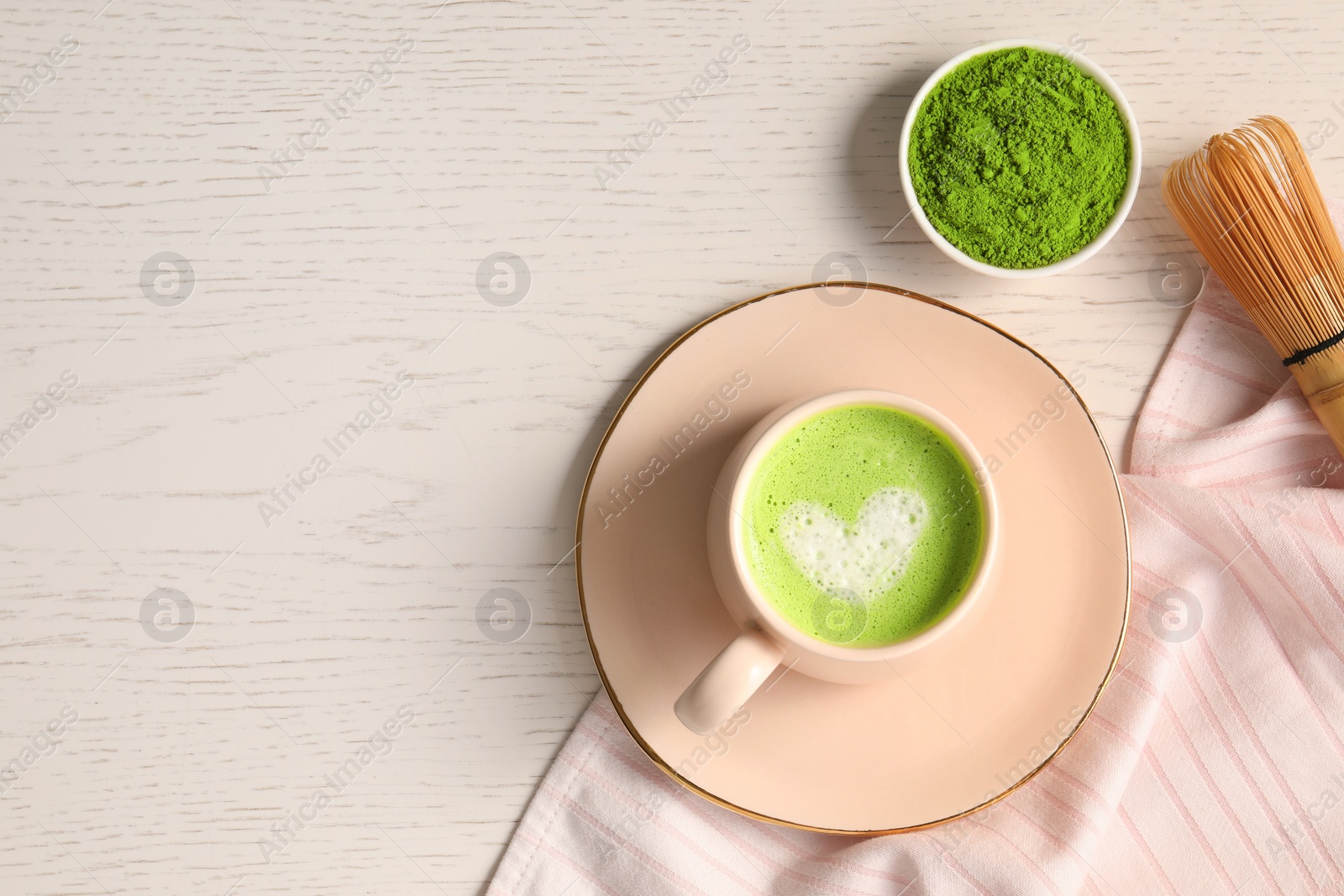 Photo of Flat lay composition with tasty matcha latte on white wooden table, space for text