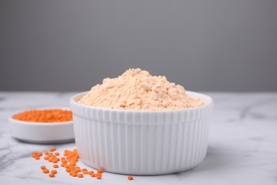 Photo of Lentil flour and seeds on white marble table