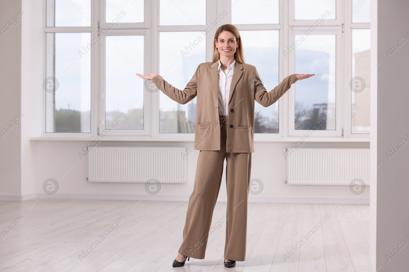 Photo of Happy real estate agent showing new apartment