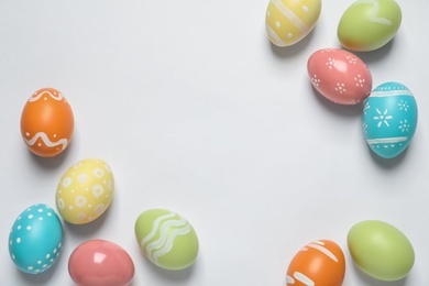 Colorful painted Easter eggs on white background, top view