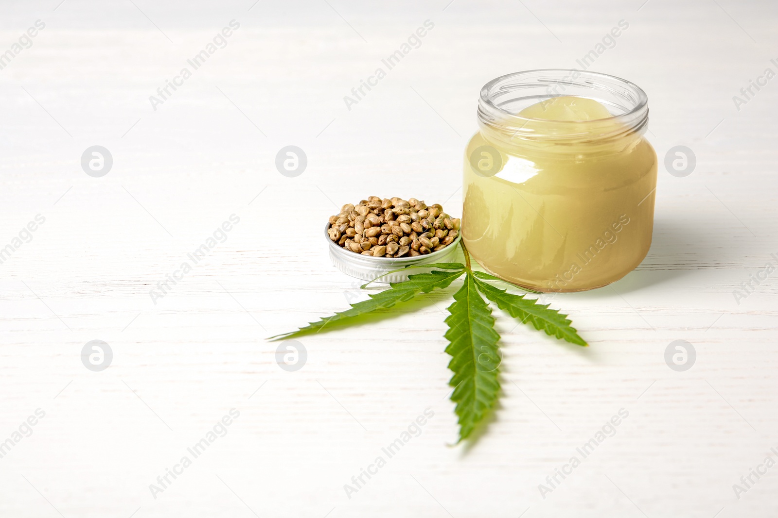 Photo of Composition with hemp lotion and space for text on white wooden background