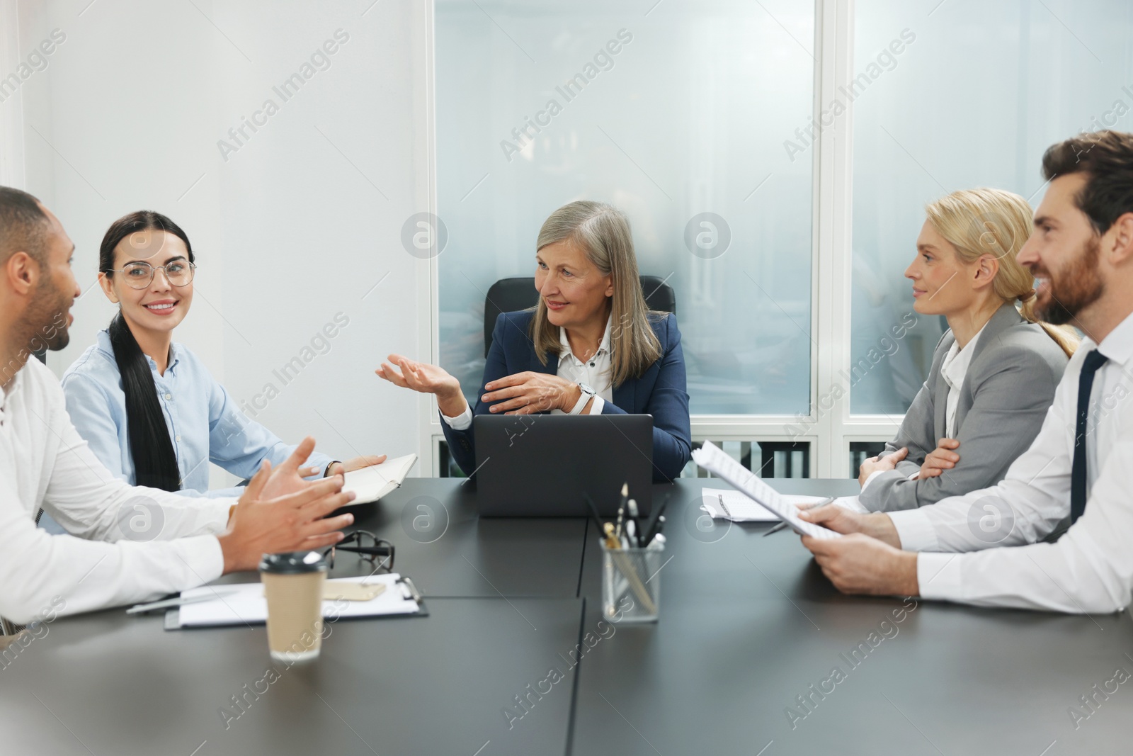 Photo of Lawyers working together at table in office