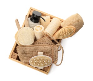 Set of toiletries with natural loofah sponges in wooden crate isolated on white, top view