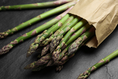 Fresh raw asparagus on black table, closeup