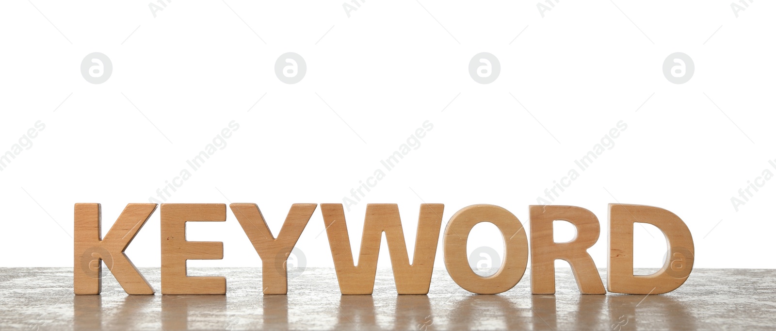 Photo of Word KEYWORD made of wooden letters on light background. Space for text