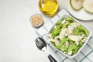 Fresh salad with pear served on light table, flat lay. Space for text