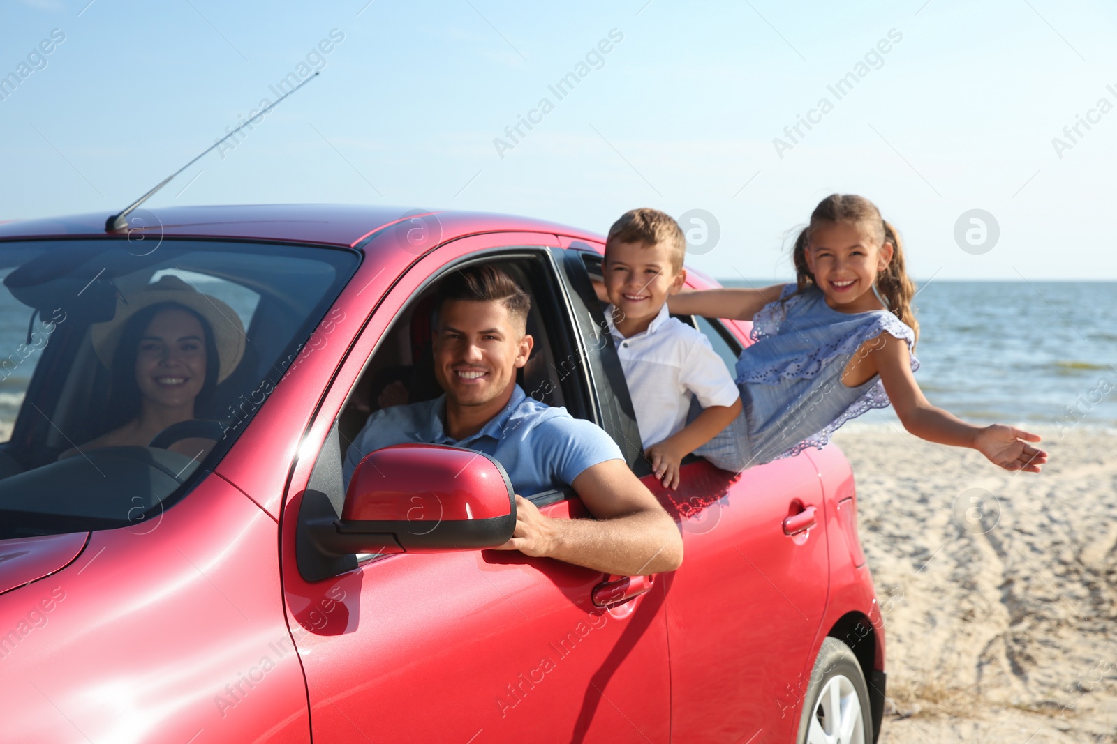 Photo of Happy family in car near sea. Summer trip