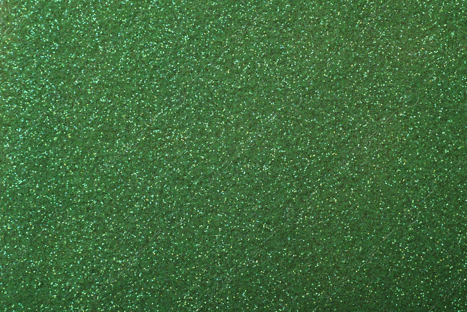 Photo of Beautiful shiny green glitter as background, closeup