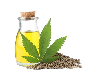 Photo of Bottle of hemp oil, fresh leaf and seeds on white background