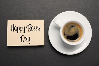 Image of Card with phrase Happy Boss`s Day and cup of coffee on black table, flat lay