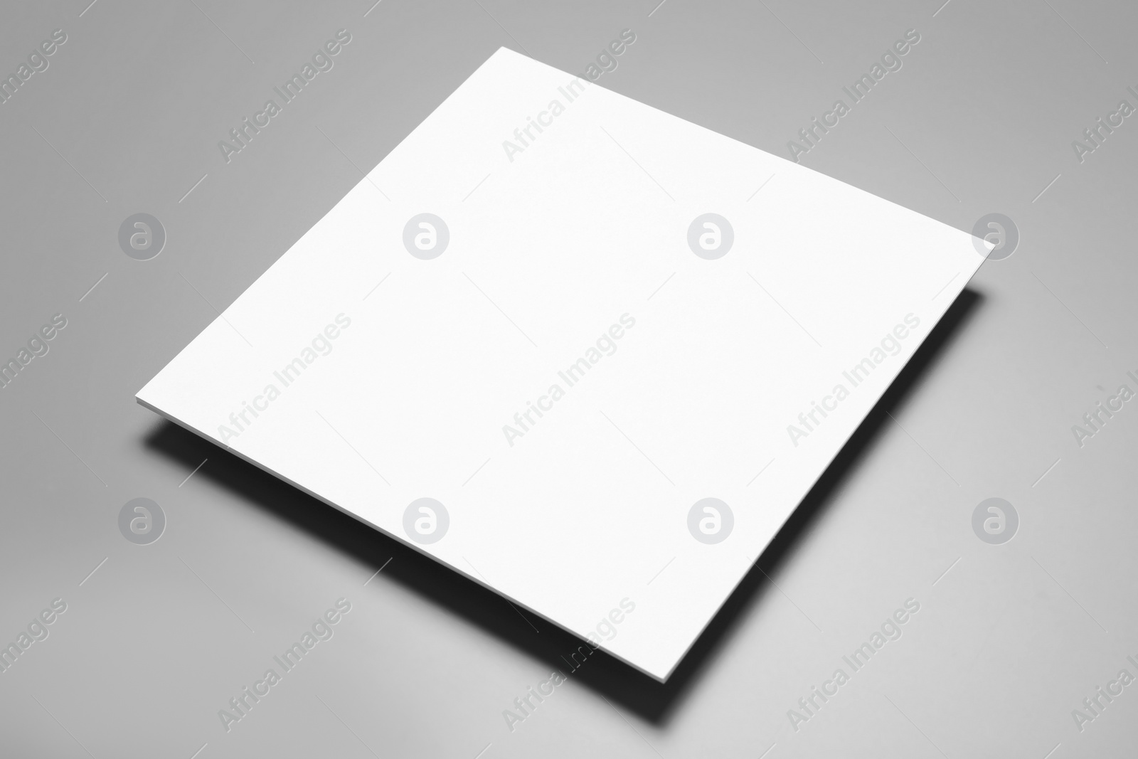 Photo of Blank paper sheets for brochure on grey background. Mock up