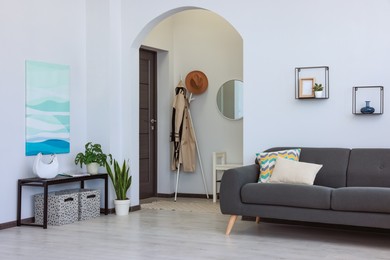 Photo of Beautiful living room interior with stylish grey sofa