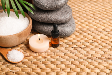 Photo of Beautiful spa composition with essential oil on wicker mat