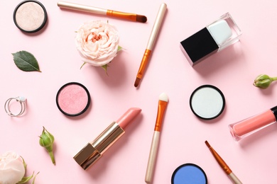 Photo of Flat lay composition with products for decorative makeup on pastel pink background