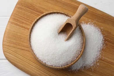 Granulated sugar on white table, top view