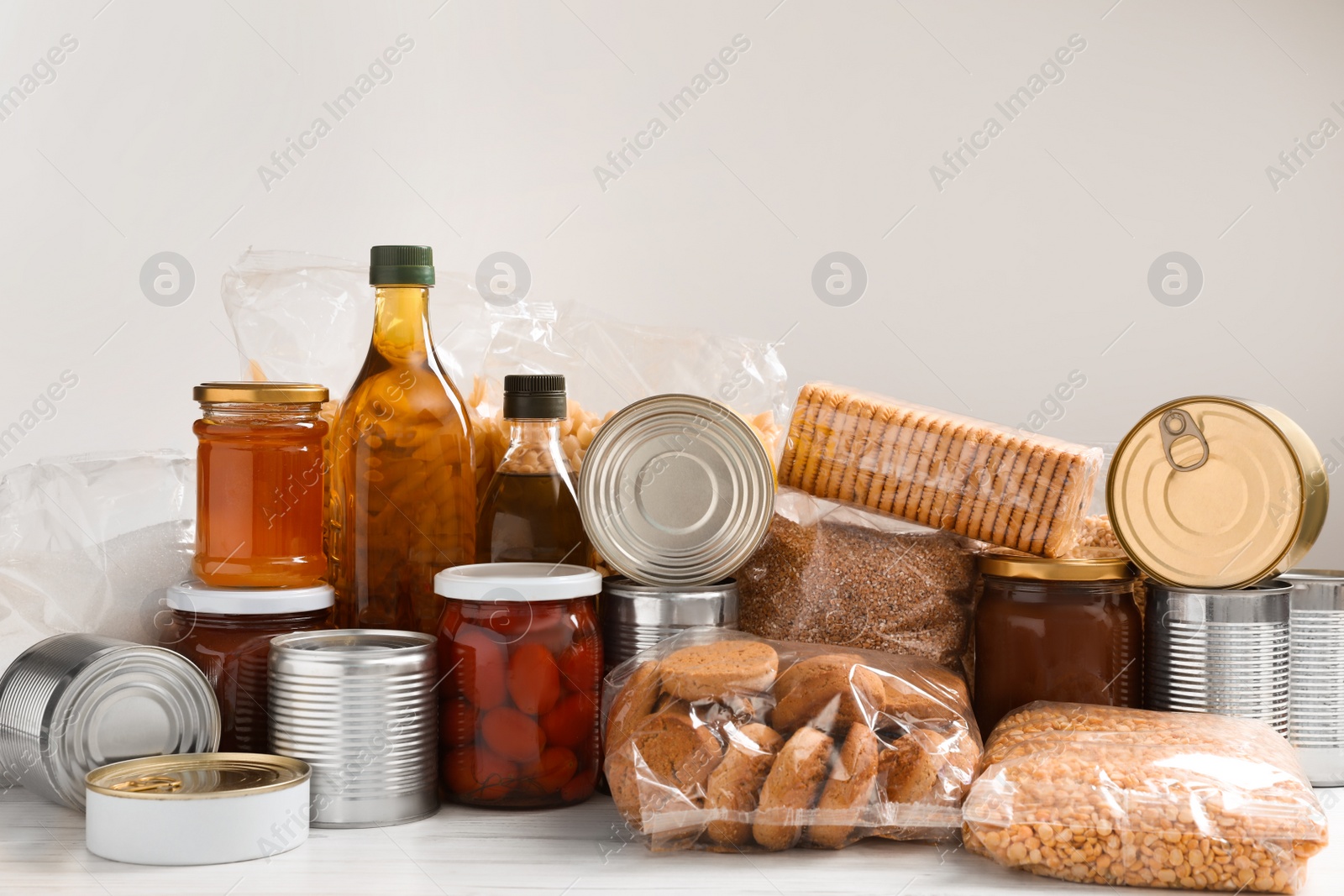 Photo of Different products on white wooden table. Food donation
