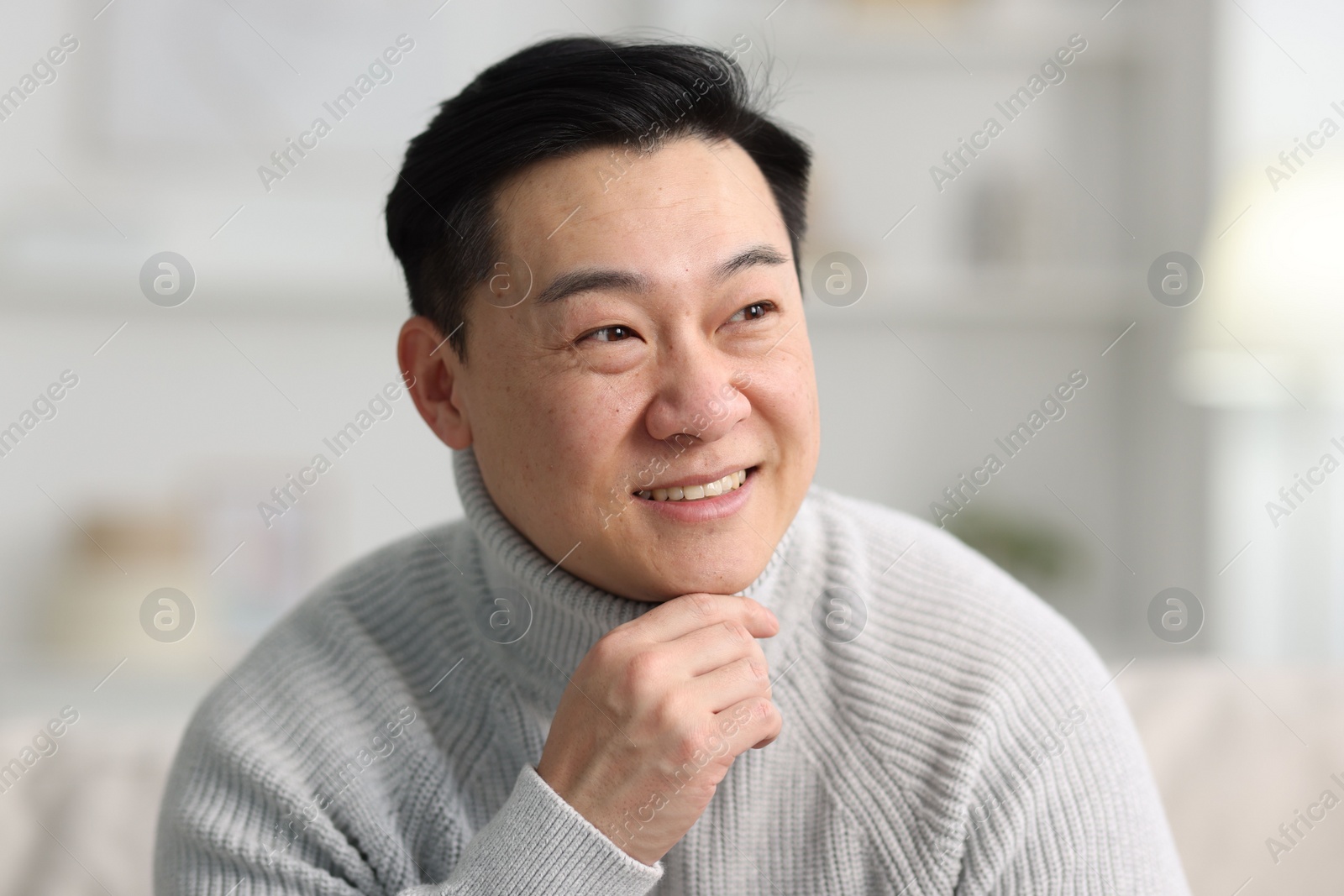 Photo of Portrait of smiling man on blurred background