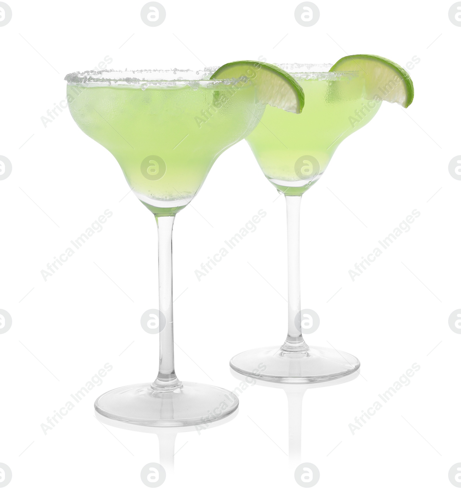 Photo of Delicious Margarita cocktail in glasses, salt and lime isolated on white