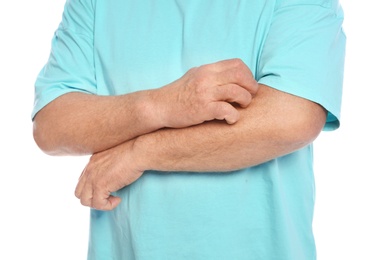 Photo of Mature man scratching arm on white background, closeup. Annoying itch