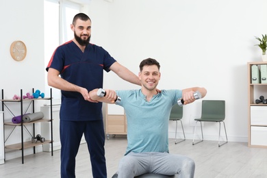 Physiotherapist working with patient in clinic. Rehabilitation therapy