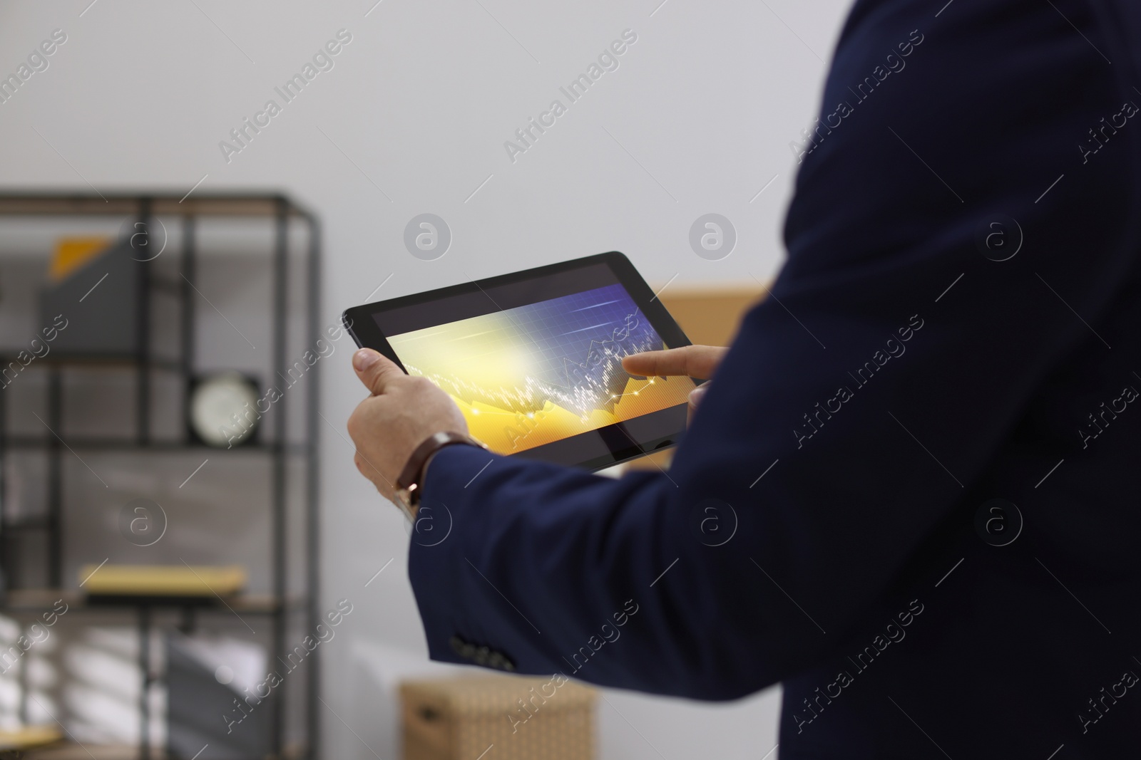 Photo of Businessman working with tablet in office, closeup. Forex trading