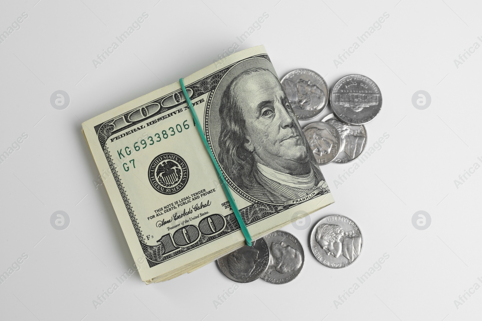 Photo of Money exchange. Dollar banknotes and coins on white background, flat lay