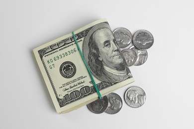 Photo of Money exchange. Dollar banknotes and coins on white background, flat lay