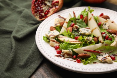 Photo of Delicious pear salad with sauce on wooden table, closeup. Space for text