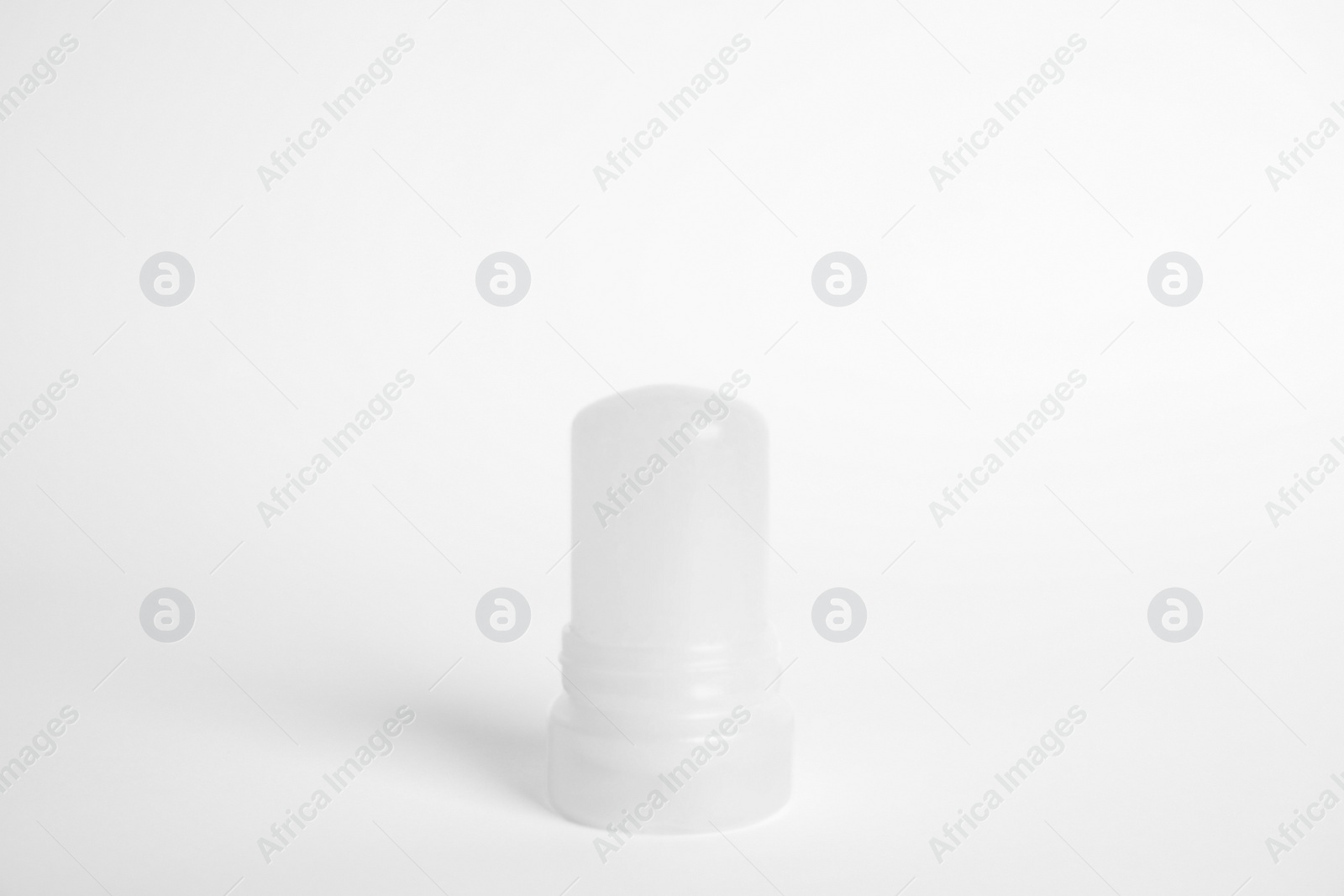 Photo of Natural crystal alum stick deodorant on white background
