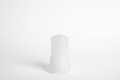 Photo of Natural crystal alum stick deodorant on white background