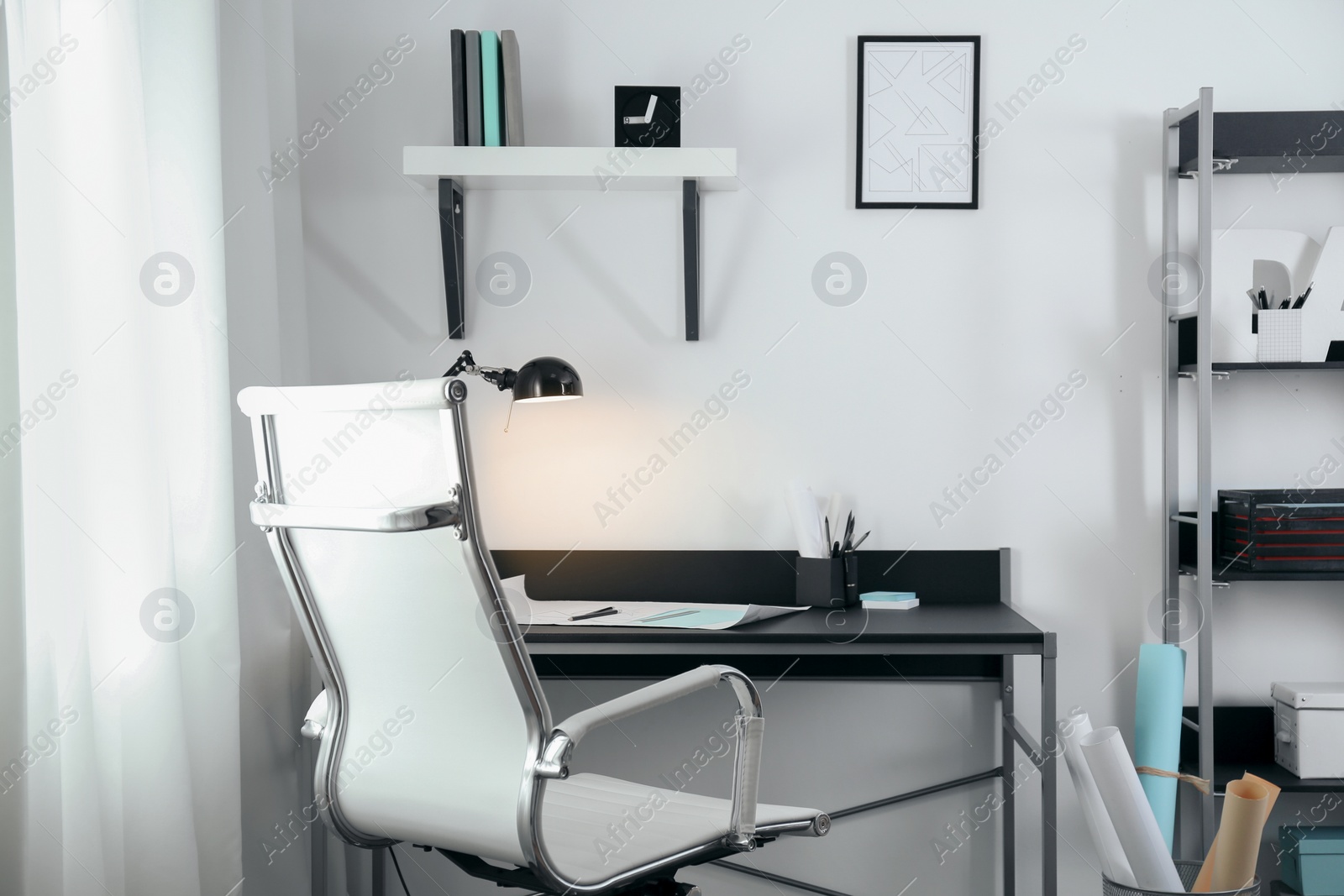 Photo of Stylish room interior with comfortable workplace near window. Design idea