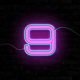 Image of Glowing neon number 9 sign on brick wall