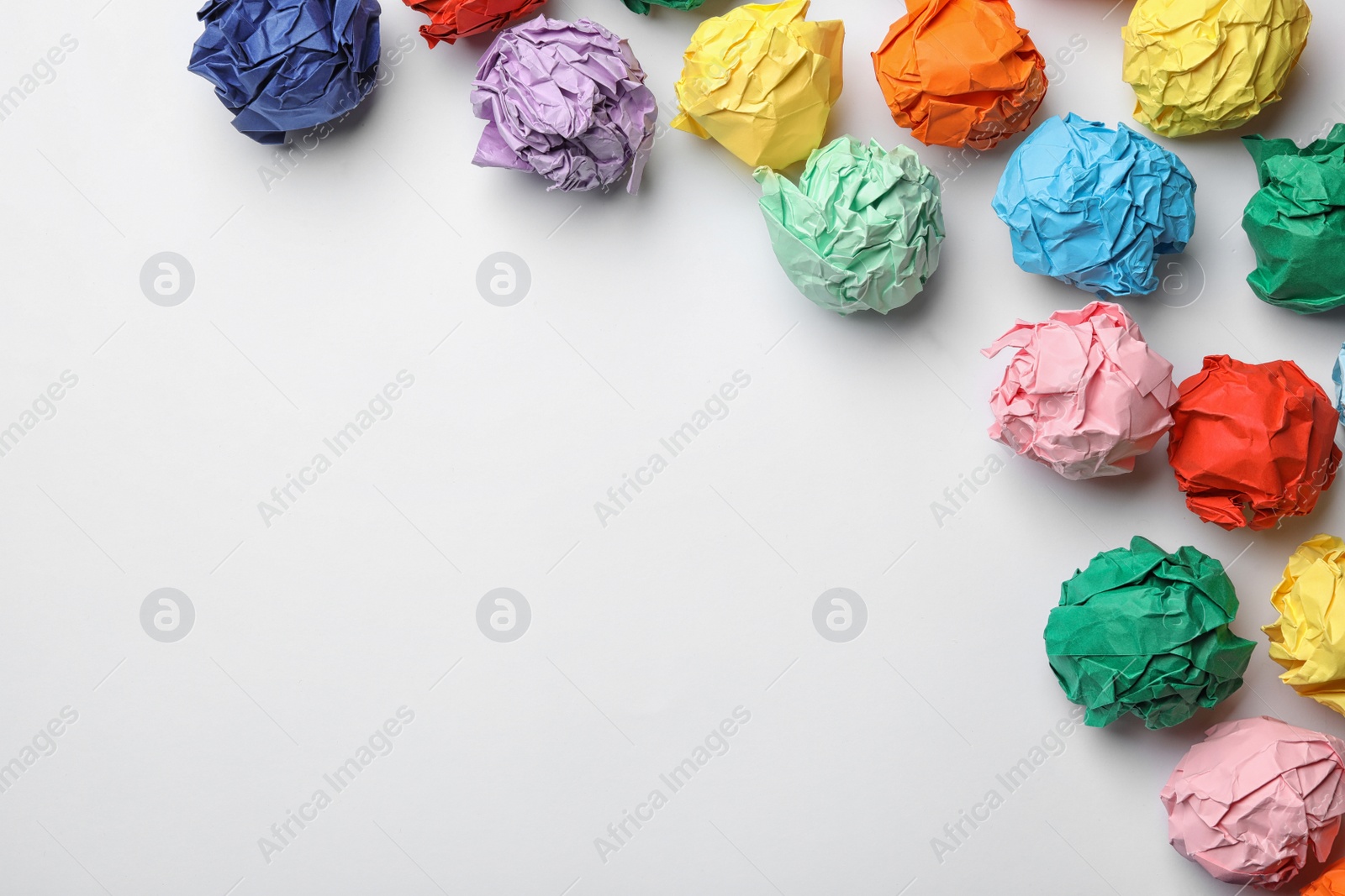 Photo of Frame made of colorful paper balls on white background, top view. Space for text