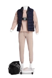 Photo of Male mannequin with accessories dressed in stylish beige tracksuit and vest isolated on white