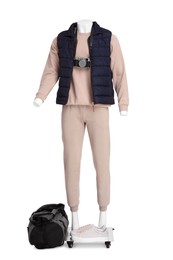 Male mannequin with accessories dressed in stylish beige tracksuit and vest isolated on white