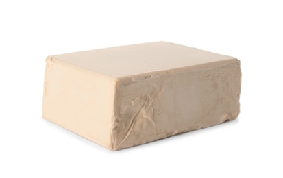 Photo of Block of compressed yeast on white background