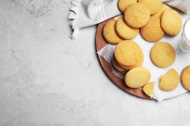 Many tasty sugar cookies on light grey table, top view. Space for text