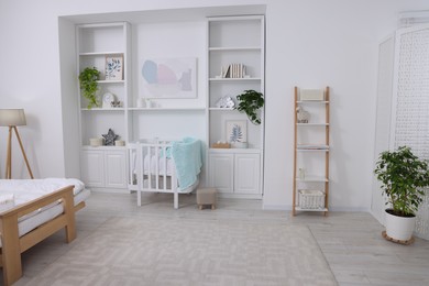 Bedroom interior with stylish crib for newborn baby