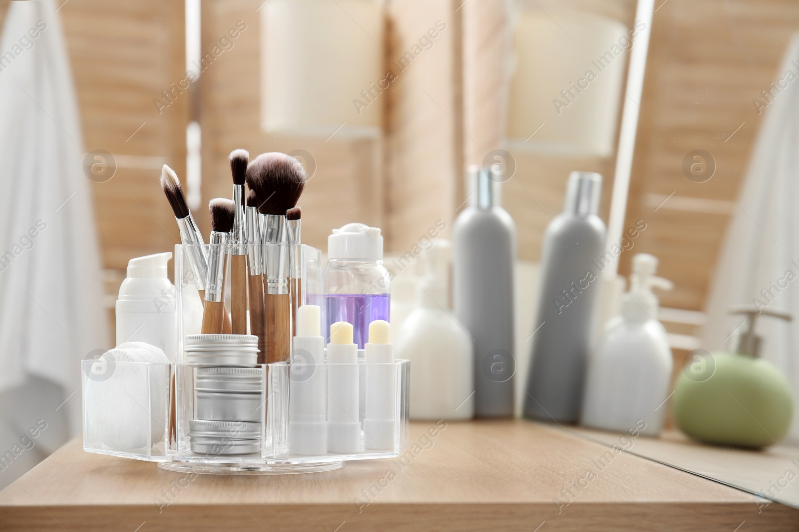 Photo of Organizer with cosmetic products and space for text on dressing table