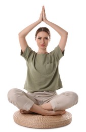 Beautiful young woman meditating on white background