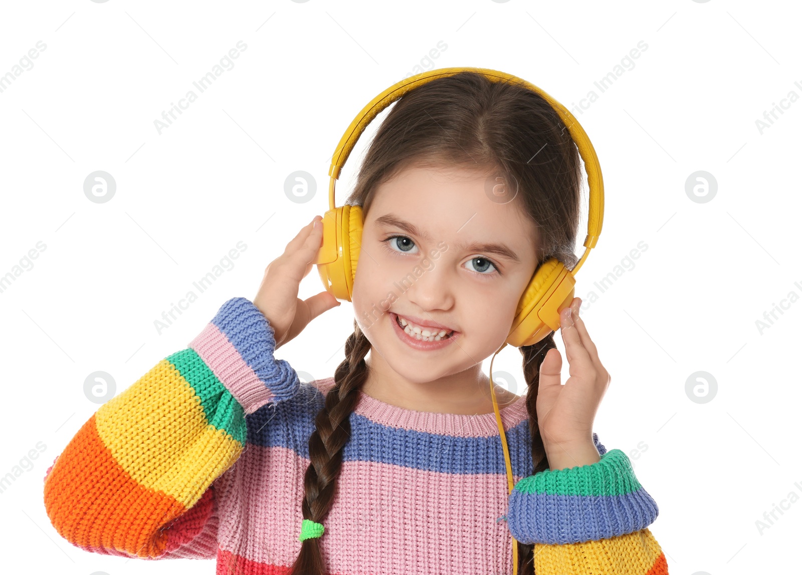 Photo of Cute little child listening to music with headphones on white background