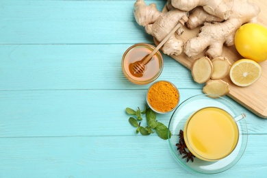 Flat lay composition with immunity boosting drink and ingredients on turquoise wooden table. Space for text