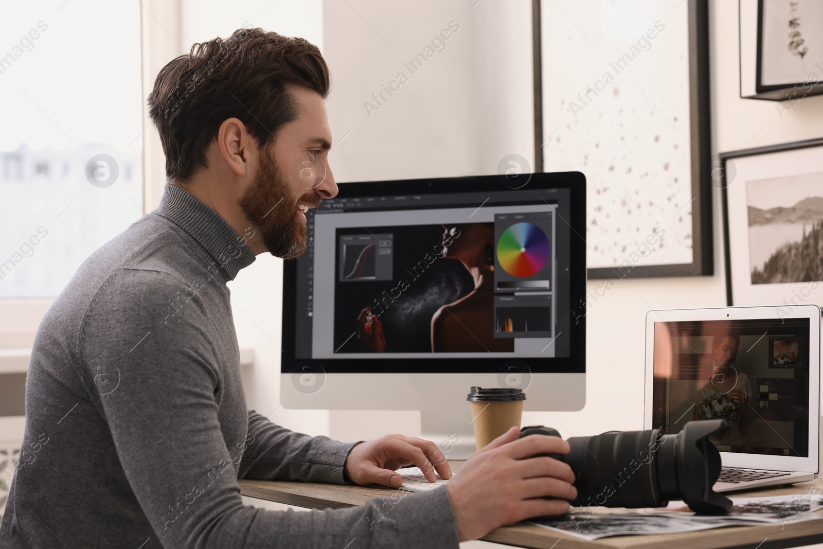 Photo of Professional photographer with digital camera at table in office