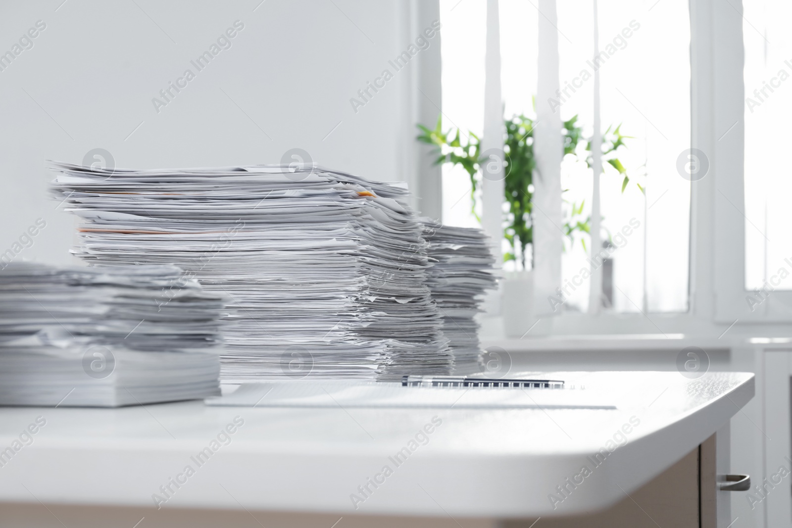 Photo of Stacks of documents on table in office