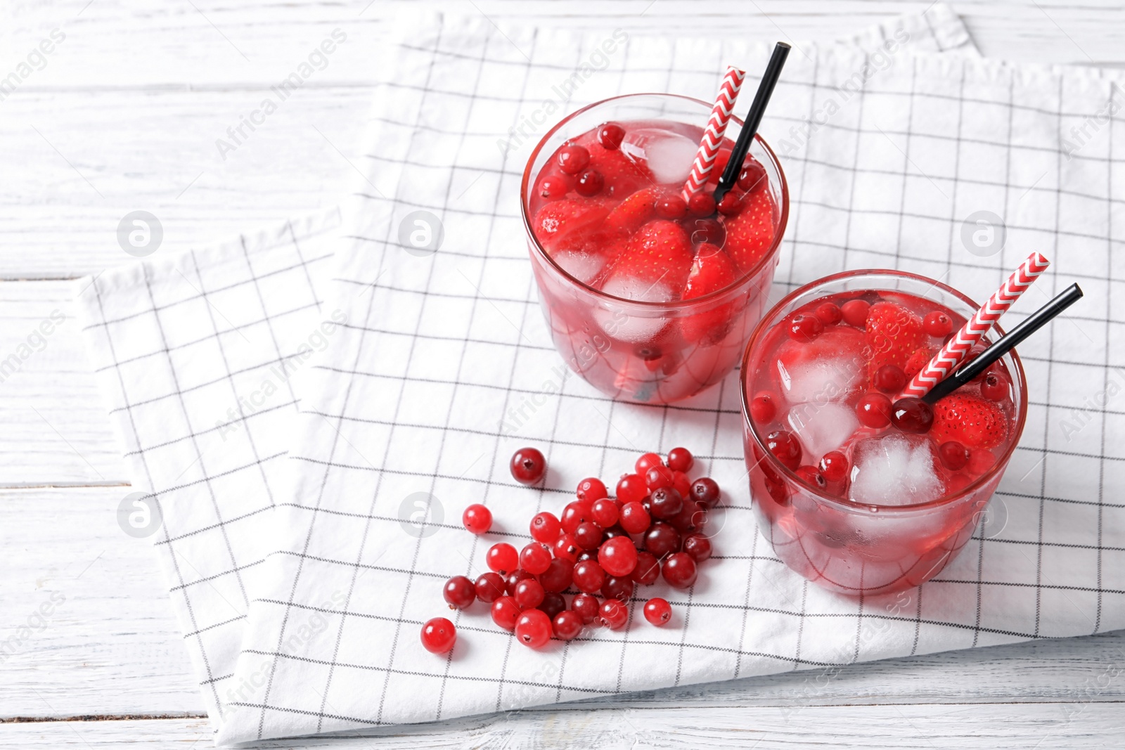 Photo of Glasses of natural lemonade with berries on table