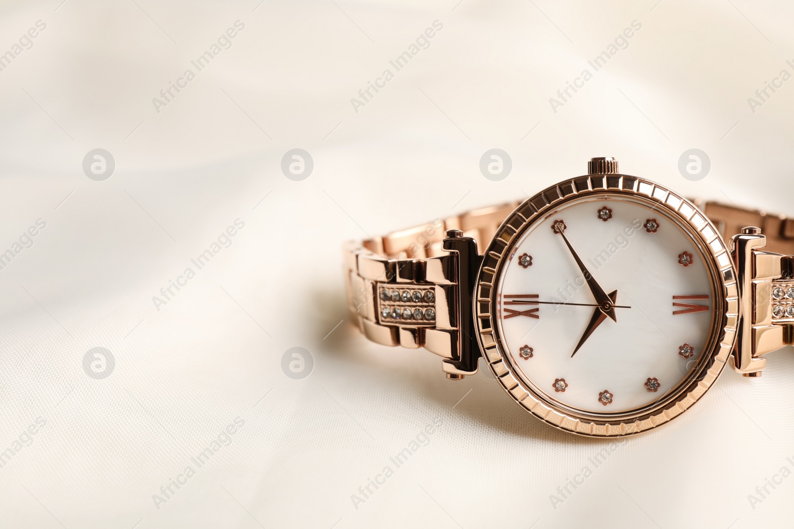 Photo of Luxury wrist watch on white background, closeup. Space for text