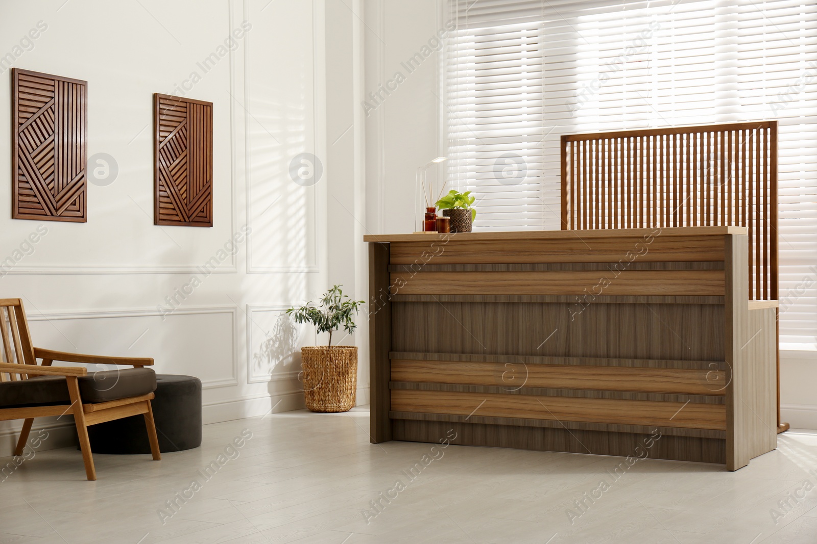 Photo of Hotel lobby interior with wooden reception desk. Stylish workplace